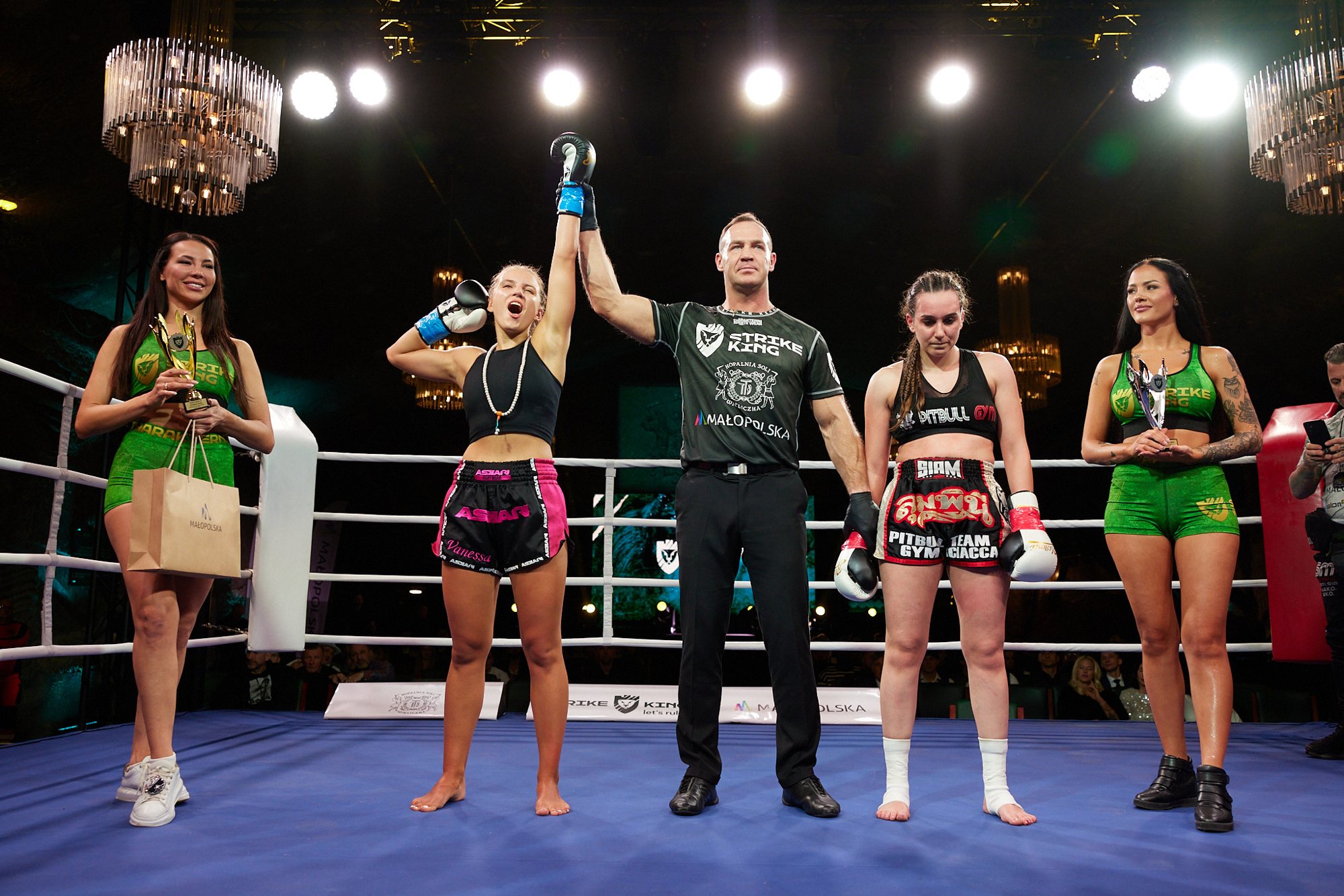 The referee raising Vanessa Romanowski's arm after the decision